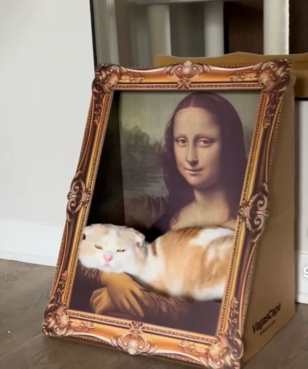 Cat relaxing inside the gilded Meowsterpiece frame