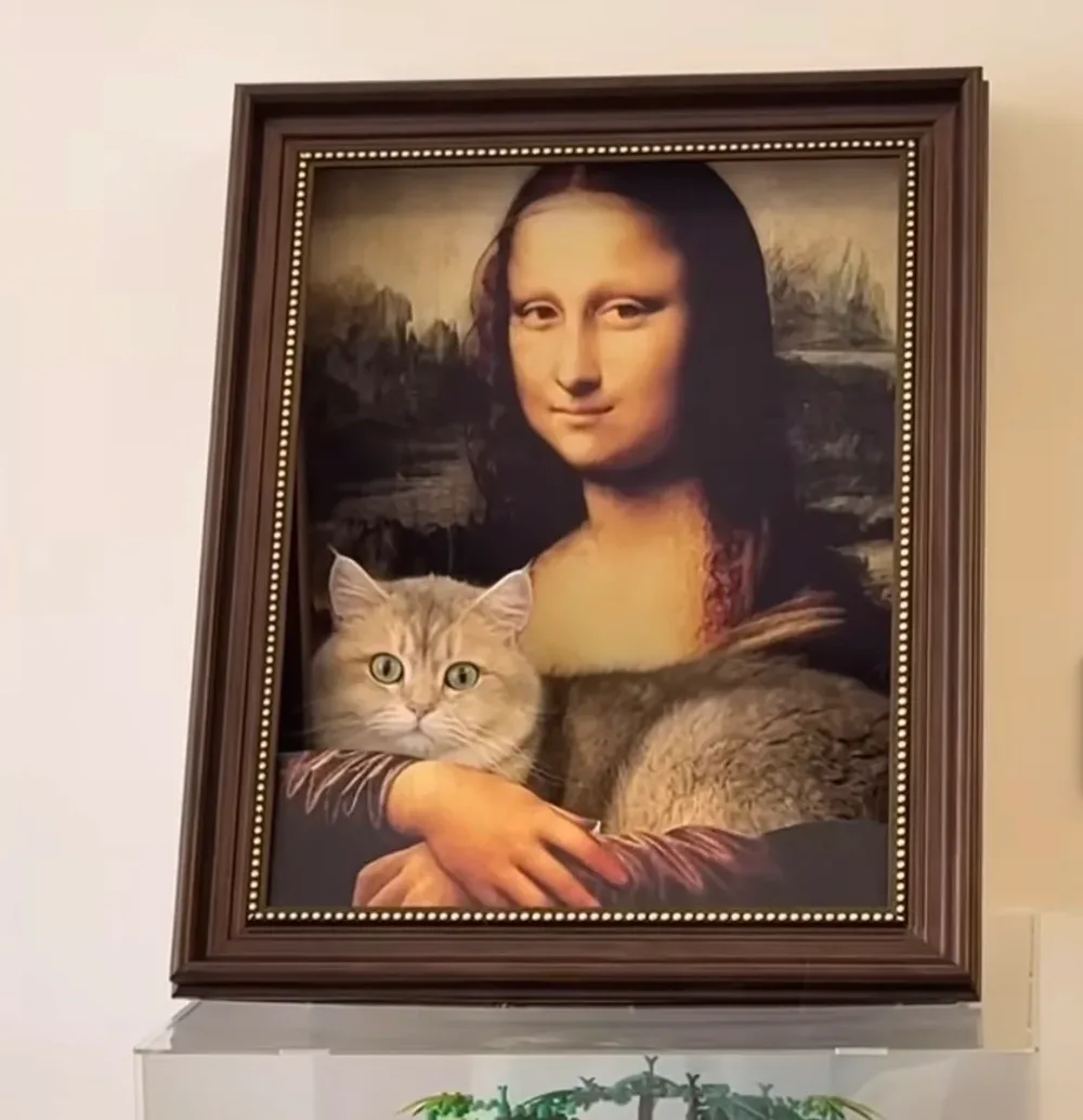 The Meowsterpiece mounted on a wall with a cat inside